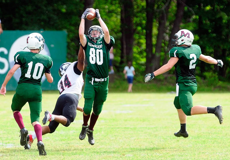 PICKED OFF: Winthrop/Monmouth’s Brandon Goff, center, intercepts a pass intended for Lisbon’s Quincy Thompson during the Ramblers’ 14-8 win over Lisbon on Saturday at Maxwell Field in Winthrop.