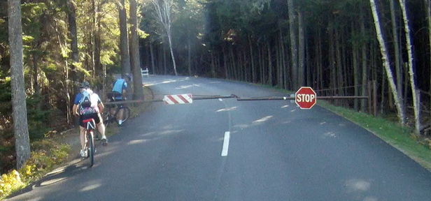 Two people bike around a gate at Acadia National Park last Thursday. Park rangers have begun ticketing people who enter the park, closed because of the government shutdown.