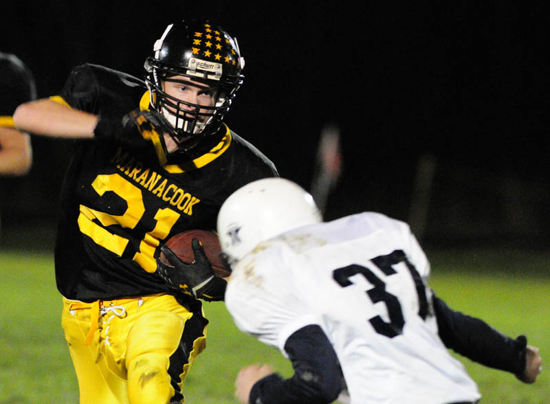 Marancook running back Christopher Robinson, left, is about to get tackled by Telstar corner back Calvin Glover on Friday night at the Ricky Gibson Field of Dreams in Readfield.