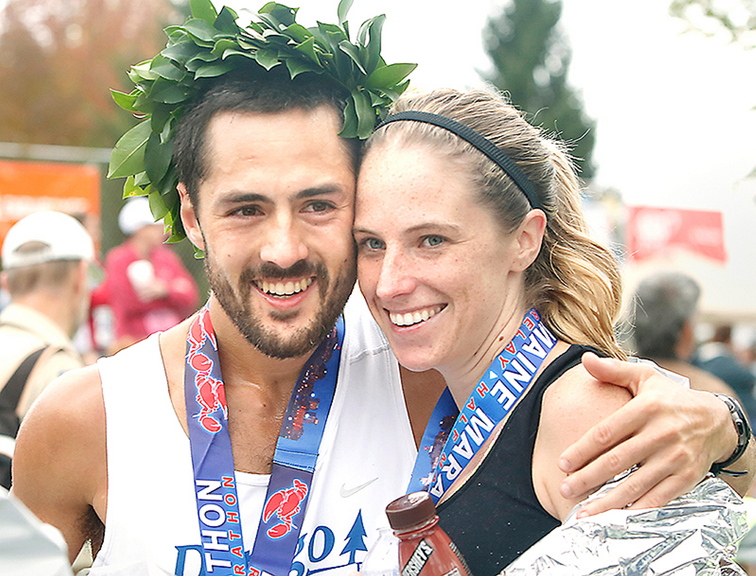 Tim Greenway/Staff Photographer Rob Gomez of Saco receives a hug from his girlfriend, Breagh MacAulay, after winning the Maine Marathon Sunday in a time of 2 hours, 24 minutes and 21 seconds in Portland.