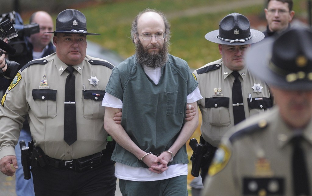 Staff photo by Andy Molloy ADMISSION: Chris Knight is escorted into Kennebec County Superior Court on Monday in Augusta to enter pleas for multiple burglaries and thefts while living in the woods of Rome, ME, for 27 years. The North Pond Hermit agreed to plead guilty in exchange for receiving an alternative sentence with the Co-Occurring Disorders Court, a special, intensive supervision program where he will live and work in the community while reporting weekly to a judge.