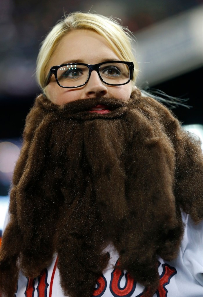 Boston Red Sox fan Shaylan Spurway sports a fake beard before Game 5 of the American League baseball championship series against the Detroit Tigers, Thursday, Oct. 17, 2013, in Detroit.