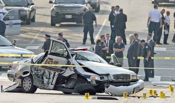 A damaged Capitol Hill police car is surrounded by crime scene tape after a car chase and shooting on Capitol Hill in Washington on Oct. 3. The driver, a mentally ill woman, was shot and killed when she tried to ram through a White House barricade, witnesses and officials said.