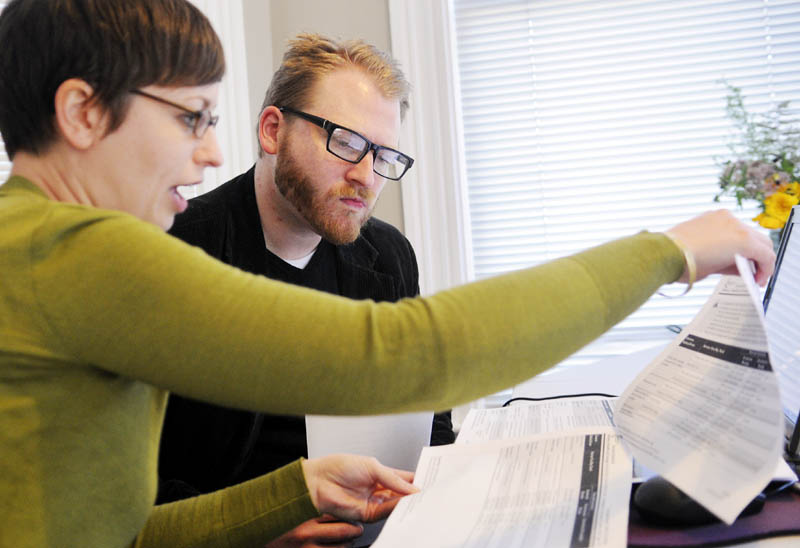 Emily Brostek, left, assists Jesse Miller, of Portland, learn about health insurance options under the Affordable Care Act today. Brostek works at the Consumers for Affordable Health Care office in Augusta.