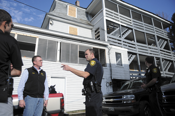 Augusta officials confer Wednesday outside of three Jefferson Street after the City of Augusta closed the building for code violations. The landlord, Rob Ray of the Lewiston based Ray Corporation, had the windows boarded up Tuesday at two adjoining properties he owns that the city cited. Over a dozen people were told to leave one and three Jefferson Street due to code violations.