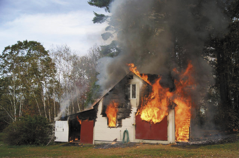 Fire ripped through this two-story garage/apartment on Mt. Pisgah Road Thursday, but a nearby home on the same property was unscathed.