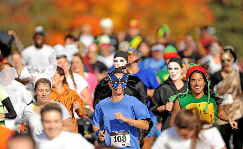Nearly 200 costume wearing runners make their way down Mayflower Hill Road at Colby College in the Freaky 5K Fun Run organized by Hardy Girls Healthy Women today. The fun run was created to help draw girls away from the scantily clad costumes and toward the scary and creative costume designs.
