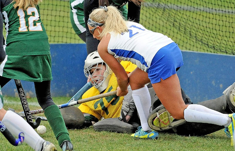 Lawrence High School's Julia Lawrence, 21, tries to get the rebound in front of the Oxford Hills High School goalie Shannon Murch, 75, in the second half in Fairfield on Thursday. Lawrence defeated Oxford Hills 1-0.