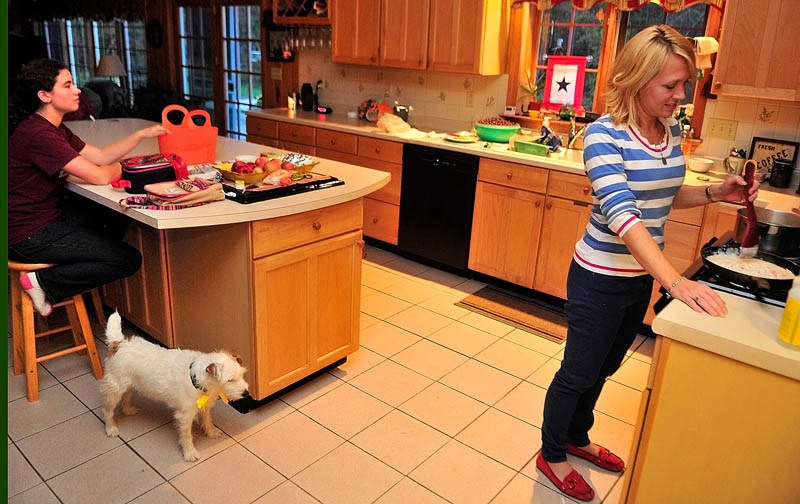 Kimberlee Lewis, left, chats with her mother, Lynn Lewis, while she makes dinner on Wednesday at their home in Monmouth.