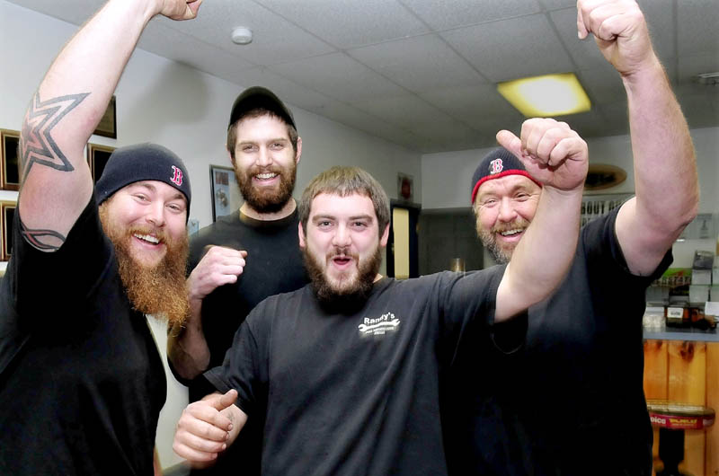 Red Sox baseball team fans whoop it up while talking about the prospects of the team winning the World Series that begins Wednesday while at Randy's Auto Repair in Skowhegan on Tuesday. From left are Mike Bruce, Dylan Adam, Quentin Frigon and Randy Bruce.