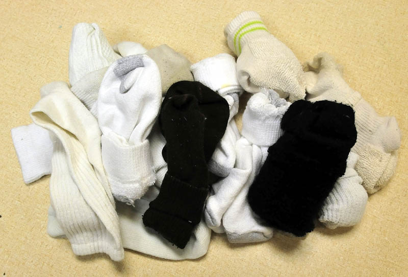 A pile of socks are available for students that need them at the George Michell School in Waterville.