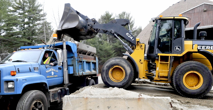WINTER ROADS: Skowhegan Highway department employees Jason Kirk, in truck, and Duane Whittemore fill up at the town sand shed to treat roads with a mixture of sand and salt on Tuesday.