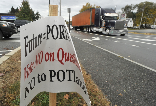 A sign advocating a no vote on Question 1, which asks to legalize marijuana in Portland, declares its position for people who use Auburn Street. The city admitted Friday that it overstepped when it removed several signs after receiving complaints about a lack of disclosure.