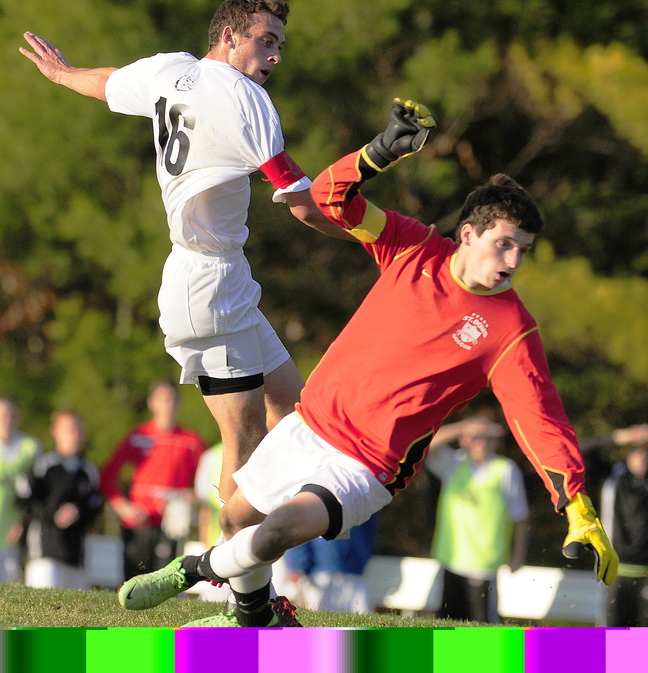 Staff photo by Joe Phelan Hall-Dale's Konnor Longfellow, left, and St. Dom's keeper Ben Sawyer watch as Longfellow's shot goes in and puts Bulldogs up 1-0 in second half of game on Saturday November 2, 2013 at Hall-Dale High School in Farmingdale.