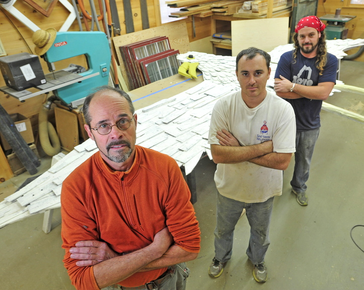 restoration crew: Stephen Dionne, left, with his employees Joe Almand, 33, center, and Dylan Daigle, 28, stand next to the 25-foot wooden seagull sculpture created by Skowhegan artist Bernard Langlais that they have restored.