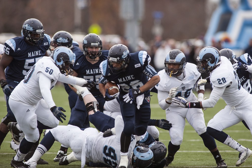 Maine running back Nigel Jones (26) is pursured by Rhode Island defensemen Shomari Watts (50) and Adam Parker (46) during the first half of Saturday’s game in Orono.