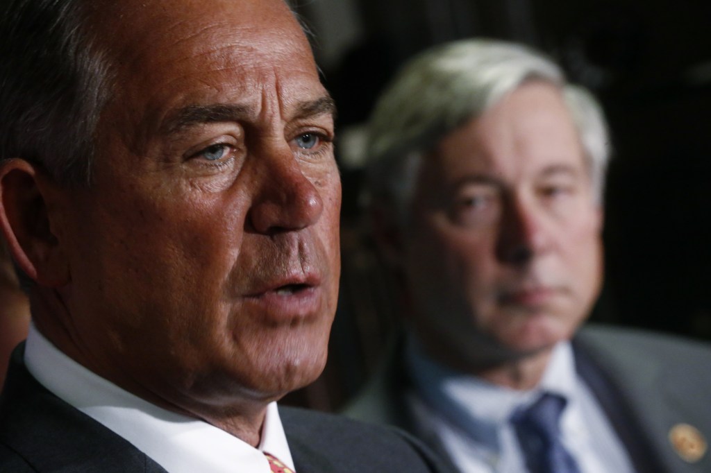 House Speaker John Boehner of Ohio, accompanied by Rep. Fred Upton, R-Mich., speaks aafter Republican lawmakers met at the Republican National Committee headquarters in Washington, Wednesday, Nov. 13, 2013.