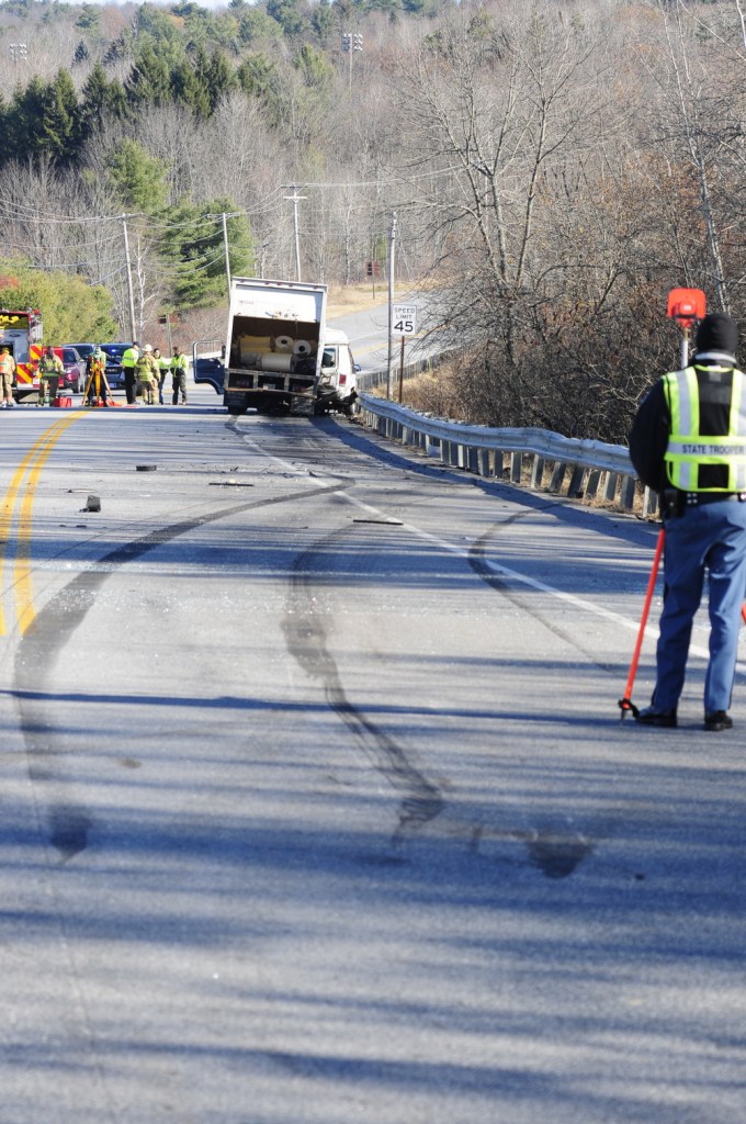 Emergency crews work at the scene of a collision between a conversion van and a panel truck near intersection of U.S. Route 202 and Royal Street on Thursday November 21, 2013 in Winthrop. State Police troopers were using surveying equipment as part of their reconstructing the accident scene.