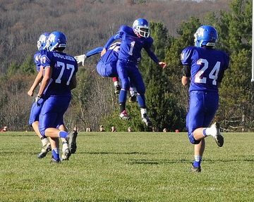 Staff photo by Joe Phelan Oak Hill kicker Adam Merrill, 1, center, celebrates after making field goal during the Western Maine Class D championship game on Saturday November 16, 2013 in Wales.