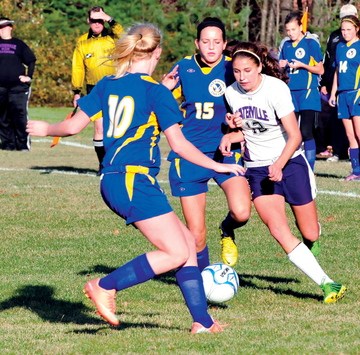PRESSURE: Waterville’s Lydia Roy, right, plays against Hermon’s Sierra Snow, 10, and Mollie Roy during the Eastern B final Wednesday in Waterville.