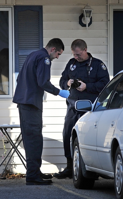 Investigators continue to work at the scene of a suspicious death on Thursday at 32 Crosby St. in Augusta
