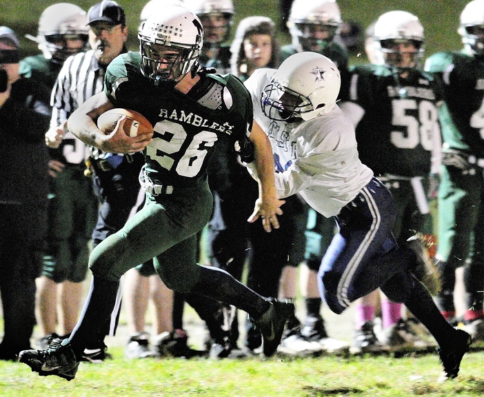 ON THE RUN: Winthrop fullback Philip Rowe gets caught by Telstar linebacker Tyler Cherkis during a game on Friday November 1, 2013 at Maxwell Field in Winthrop.