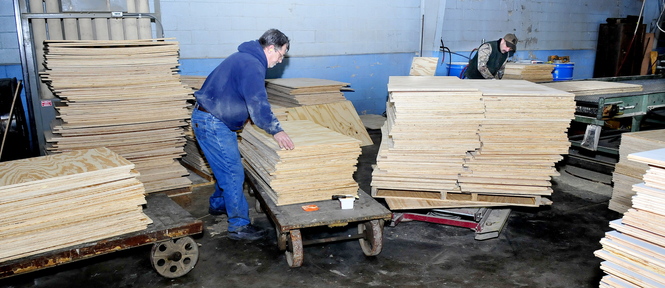 CHANGES: Cousineau Wood Products employees Darrell Clark, left, and Jerry Chestnut work on flooring stock at the North Anson company on Thursday.