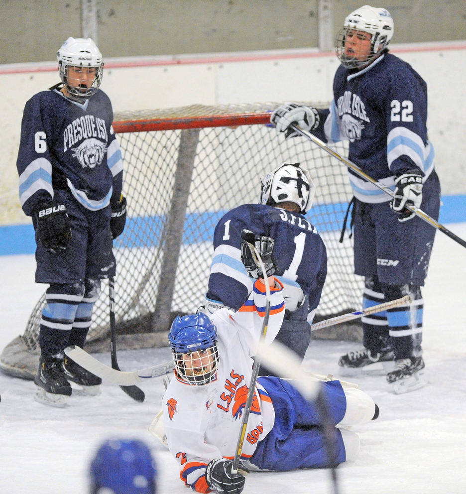 SCORE: Lawrence/Skowhegan player Andrew Carpenter (2) celebrates a goal against Presque Isle during the season opener for both teams Friday at Suke Arena in Winslow. .