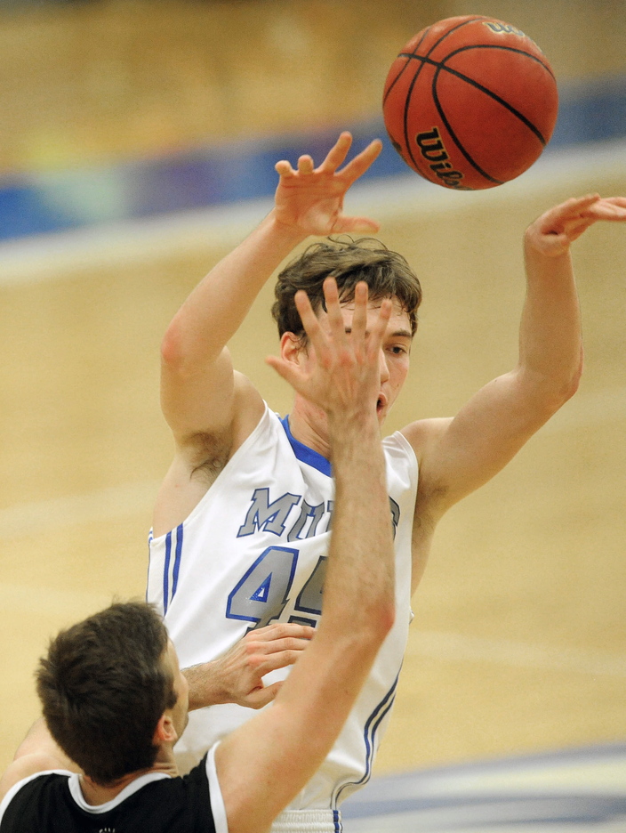 Staff photo by Michael G. Seamans COLLEGE BASKETBALL: Colby College's Patrick Stewart, 45, passes the ball ove a Bowdoin College defender in the second half at Wadsworth Gymnasium at Colby College in Waterville on Saturday.