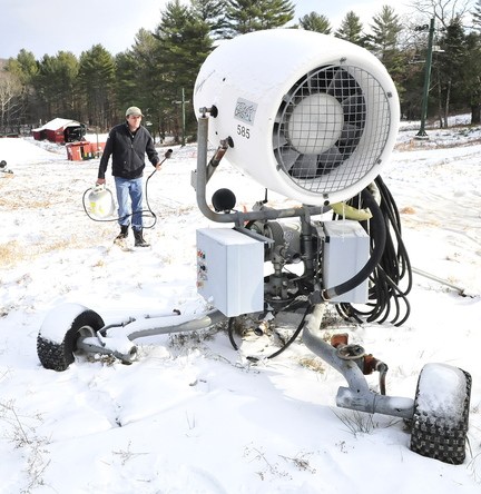 COOL: Dave Beers uses a propane heating torch to thaw frozen equipment on one of the two new snow guns at Eaton Mountain in Skowhegan on Wednesday.
