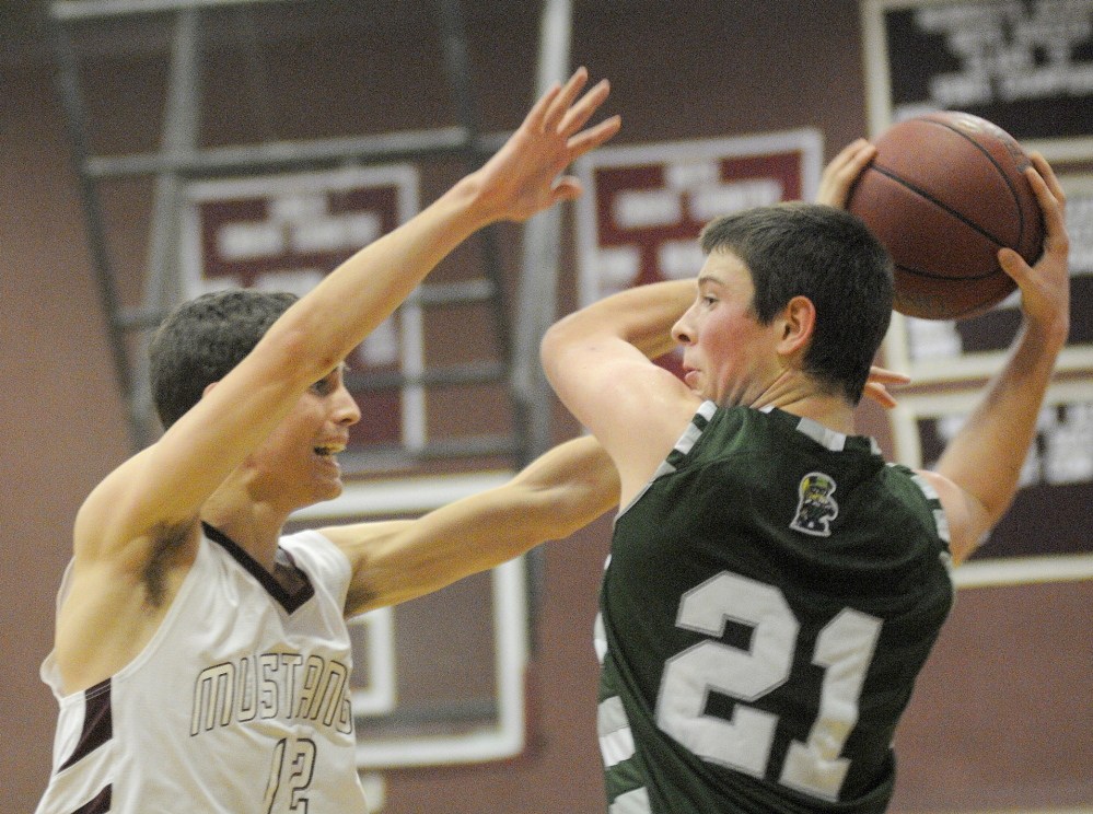 Staff photo by Andy Molloy OPEN ARMS: Monmouth Academy's Brett Wilson, left, attempts to block a pass Thursday by Winthrop High School's Matt Sekerak during a basketball match up in Monmouth.