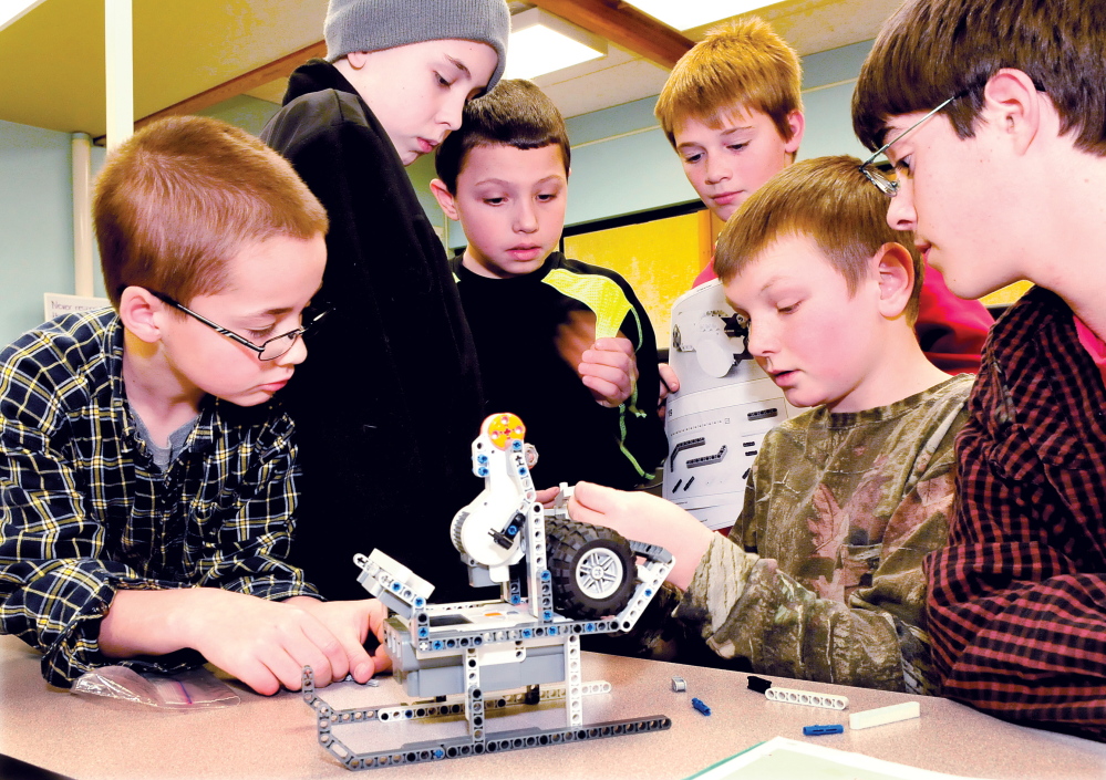 PIECE BY PIECE: Clinton Elementary School students assembled a Lego Santa Claus in a sleigh at the school this week. From left are Devin Harriet, Zachary Delile, Damien Peavey, Cody Dixon, Bryce Dostie and Ethan Cochrane.