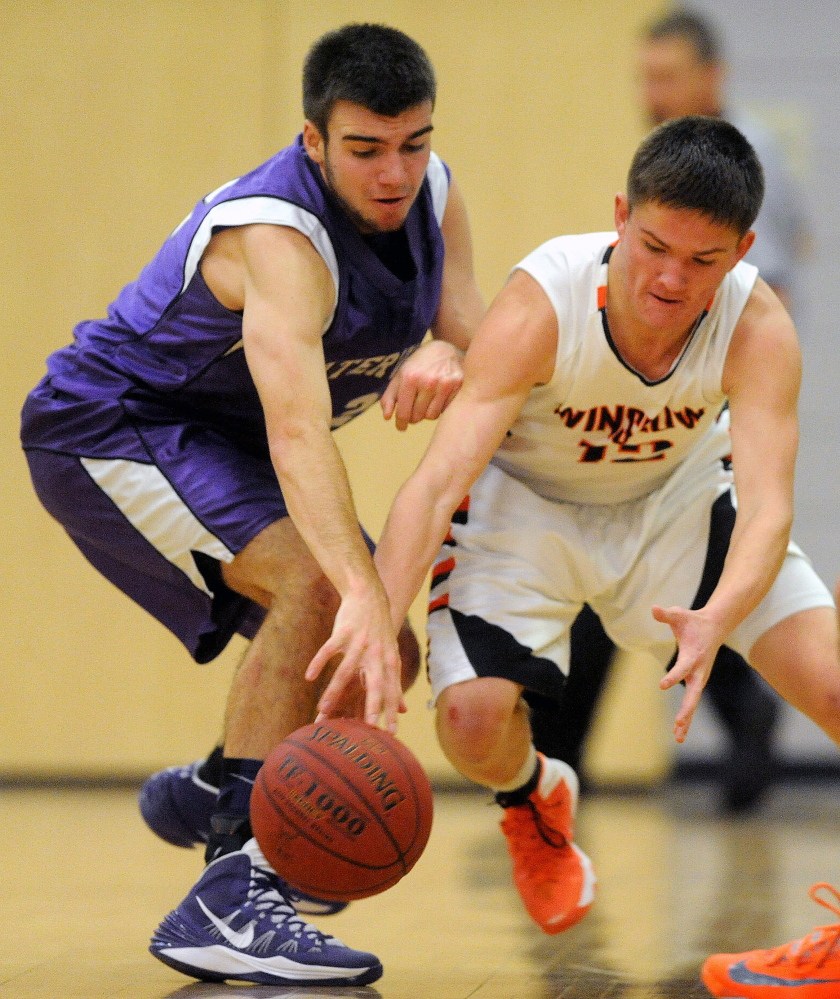 HIGH SCHOOL BASKETBALL: Winslow High School’s Connor Wildes, 12, tries to steal the ball from Waterville Senior High School’s Justin Jabar, 12, in the first quarter in Winslow on Saturday.
