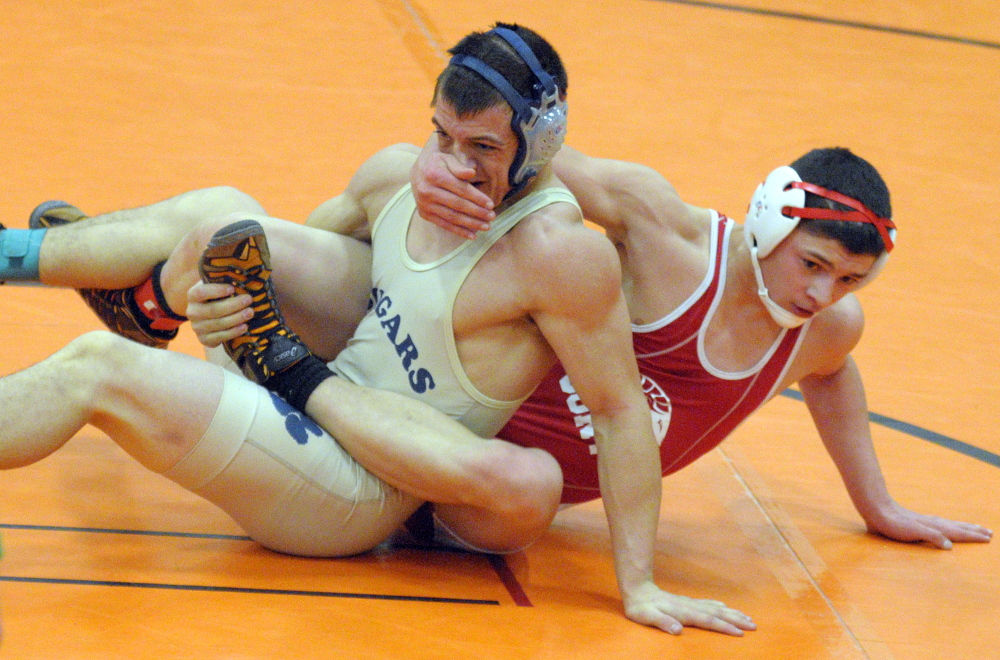 Mount Blue’s Nick Hickey, left, and Cony’s Victor Tapia-Smith compete in a 160-pound championship semi-finals match during the Tiger Invitational on Saturday December 14, 2013 in the John A. Bragoli Memorial Gym in Gardiner. Hickey eventually pinned his opponent to win in overtime.