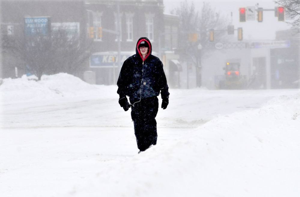 SOLITUDE: Shannon Mullen had Main Street in Waterville to himself as he walked to Waterville Commons to shovel snow on Sunday.