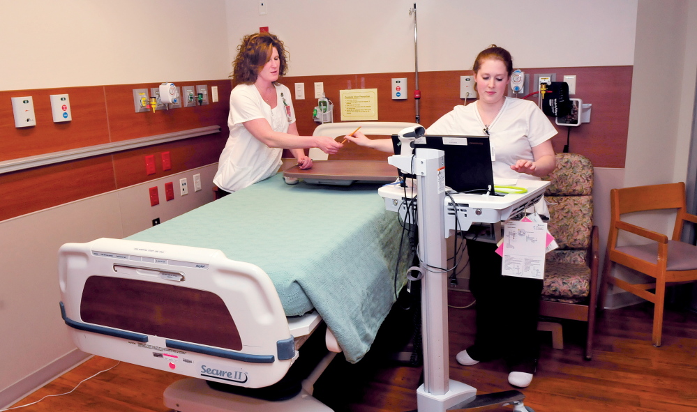 IMPROVEMENTS: Inland Hospital nurses Samantha Blaney, left, and Dyani Smith in the acute care unit on Monday. The Waterville City Council will consider on Tuesday whether to issue a $6 million revenue bond for improvements to the Waterville facility.