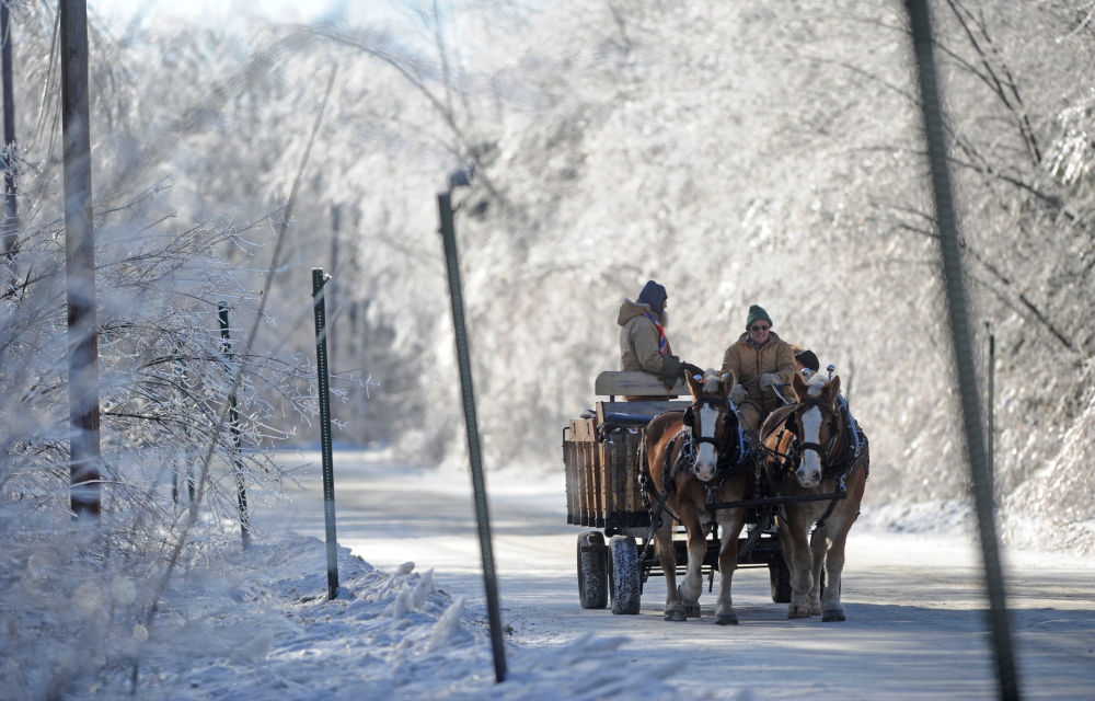 Staff photo by Michael G. Seamans CHRISTMAS IN WATERVILLE: The trademark hay rides for patrons of the 7th annual Central Maine Family Christmas Dinner drives down the icy tunnel of Industrial Parkway in Waterville on Wednesday, Dec. 25, 2013.