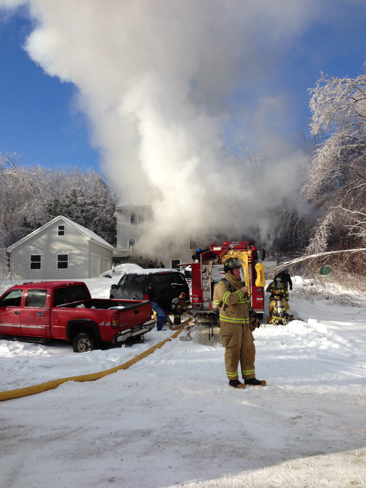 FIRE RESPONSE: Crews respond to a fire at Fire Road 14 in China Friday morning. Homeowner Neil Farrington saved his disabled brother-in-law from the blaze, but the home was a loss.