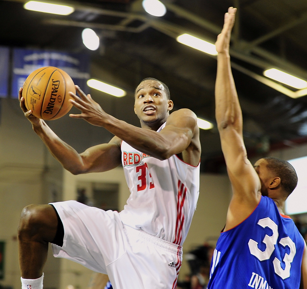 Red Claws Chris Wright takes it up for two over Delaware’s JR Inman as Maine hosts the 87ers at the Portland Expo on Tuesday.