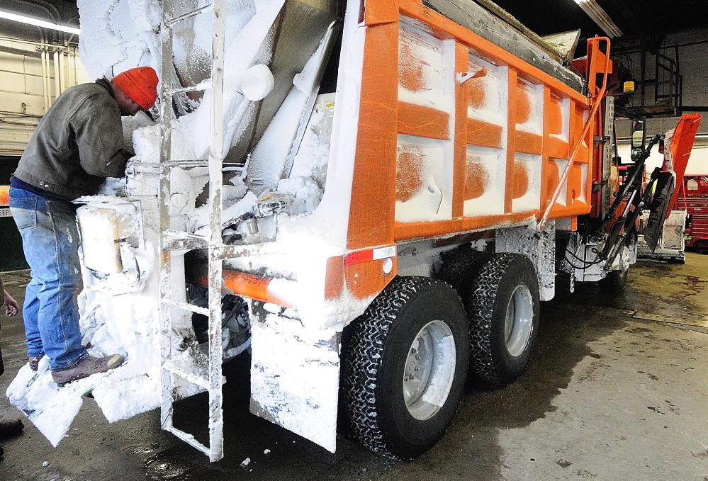 SLICK ROADS: Mechanic Rick Merrill fixes a nozzle on a liquid calcium chloride dispenser on the back of a plow truck on Friday in the garage at the John Charest Public Works Facility in Augusta.