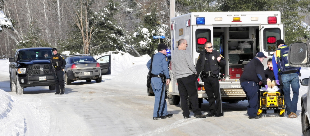 SELF INFLICTED: A man is loaded into an ambulance with injuries to his face that police say was self inflicted following a domestic dispute with a women at a residence on the Horseback Road in Clinton on Sunday, Jan. 5, 2014. Police from several agencies including Clinton, Waterville, State Police and Kennebec Sheriff Office responded. The woman was transported by ambulance as a precaution.