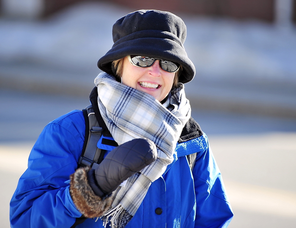 Dressed for the cold weather, Rhonda Grigg heads for some downton shopping as she walks from the Eastern Prom to Congress Street on Tuesday.