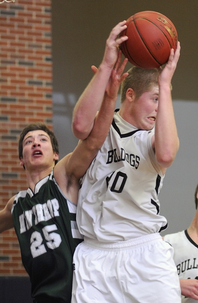 Staff photo by Joe Phelan Winthrop's Dakota Carter, left, and Hall-Dale's Brian Allen go up for a rebound during a game on Tuesday January 7, 2014 in the Penny Memorial Gymnasium at Hall-Dale High School in Farmingdale.