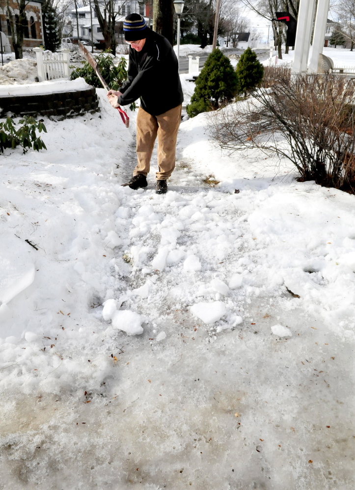 Staff photo by David leaming NICE SWING: Swinging a shovel like a golf club Shawn Zeimetz knocks snow over an ice-covered sidewalk for added traction at a home in Fairfield on Sunday, Jan. 123, 2014.
