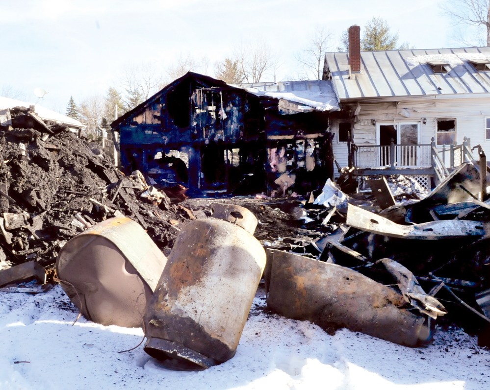 DAMAGE: Embden homeowner Clayton Williams said he suspected that gas escaped from propane tanks and contributed to the fire that heavily damaged his home on Sunday. He said that he first saw smoke coming from the back of the building on Dunbar Hill Road.