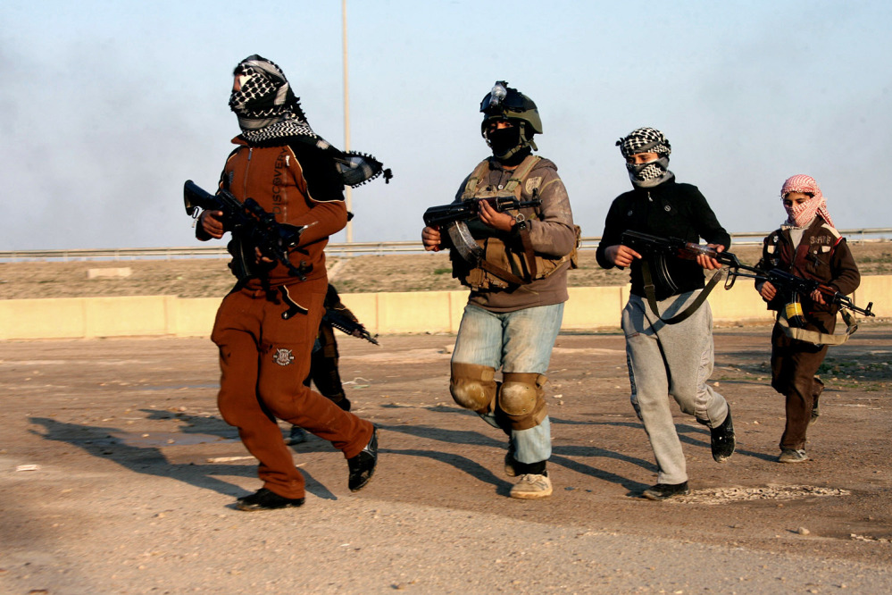 Gunmen patrol Fallujah 40 miles west of Baghdad, Iraq, on Wednesday. Iraqi airstrikes pounded a town near Fallujah that had been seized by al-Qaida linked militants and commandos swept in Wednesday to clear the area, senior military officials said.
