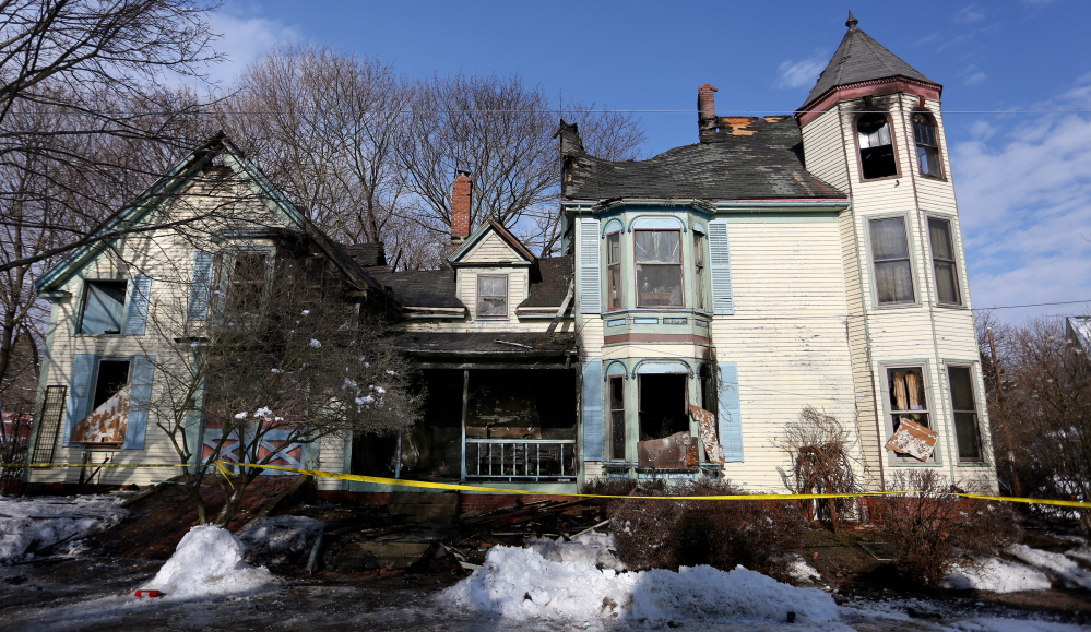 The building that once housed the owner and three renters sits in ruins Monday. Two guests also escaped the blaze.