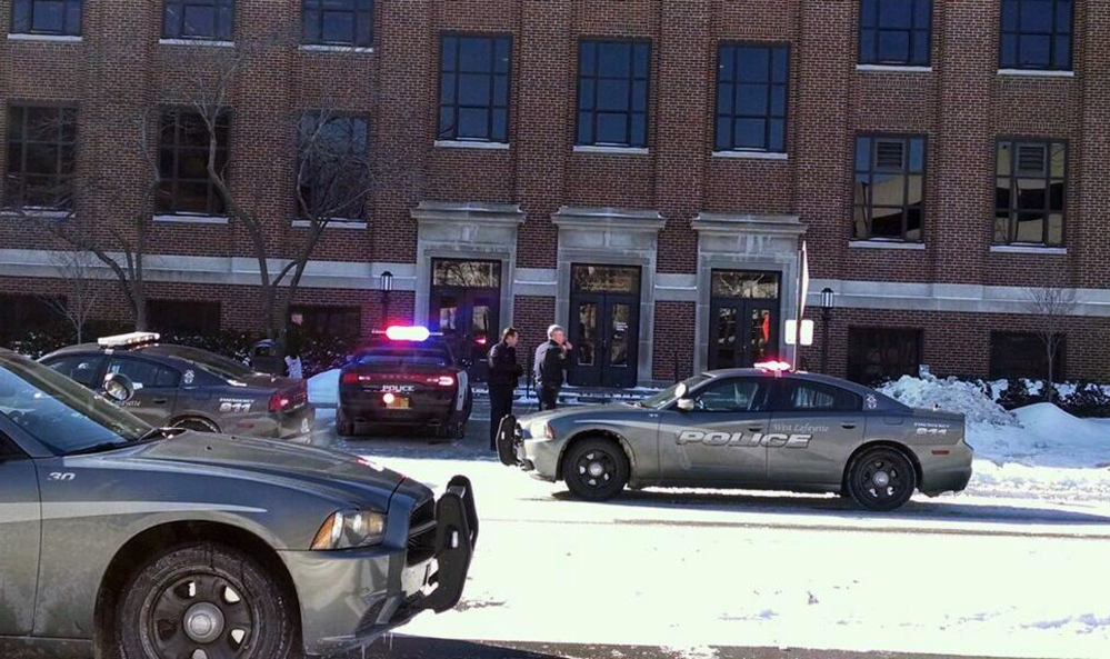 Police investigate reports of a shooting at Purdue University in West Lafayette, Ind., on Tuesday. Police say they have a person in custody and the university says it told people to take shelter and have cleared the building as the area is searched.