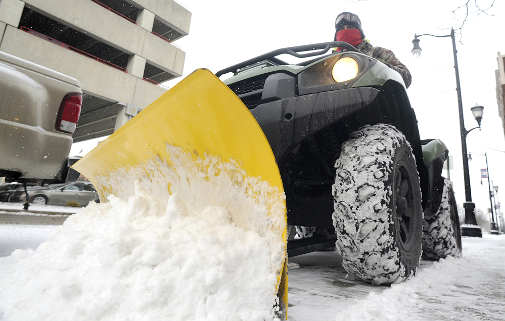 Dave Lewis of the Wilkes-Barre City Operations Department clears a sidewalk on North Washington Street, Tuesday, Jan. 21, 2014, in Wilkes-Barre, Pa. The National Weather Service has issued a winter storm warning for Tuesday’s storm with public schools closed in parts of central Pennsylvania and elsewhere.