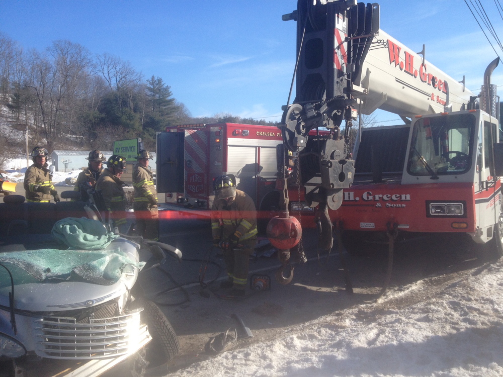 TRAPPED: Firefighters extricate Sally Grouse Thursday, who was trapped after her car collided with a crane on Route 9 in Chelsea. Crews worked for a half-hour to remove her from her totaled PT Cruiser.